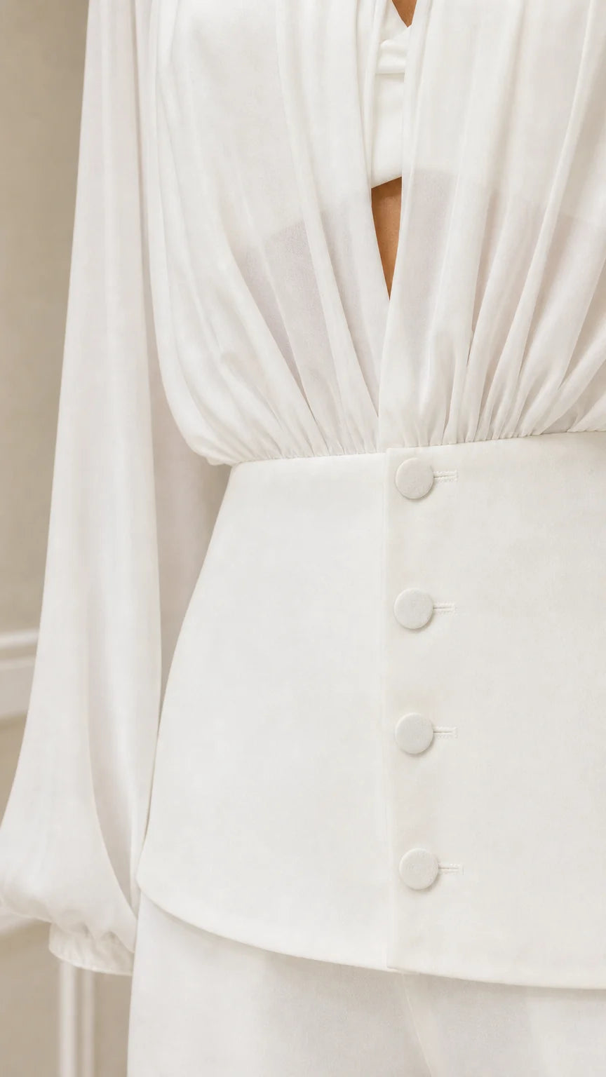 Close up of white blouse button down waist and gathering detail