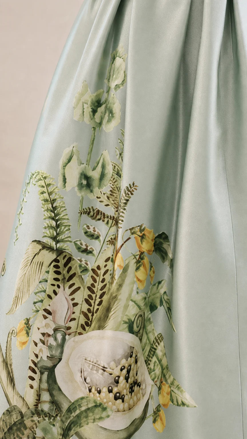 Close-up detail of botanical embroidery on dress skirt