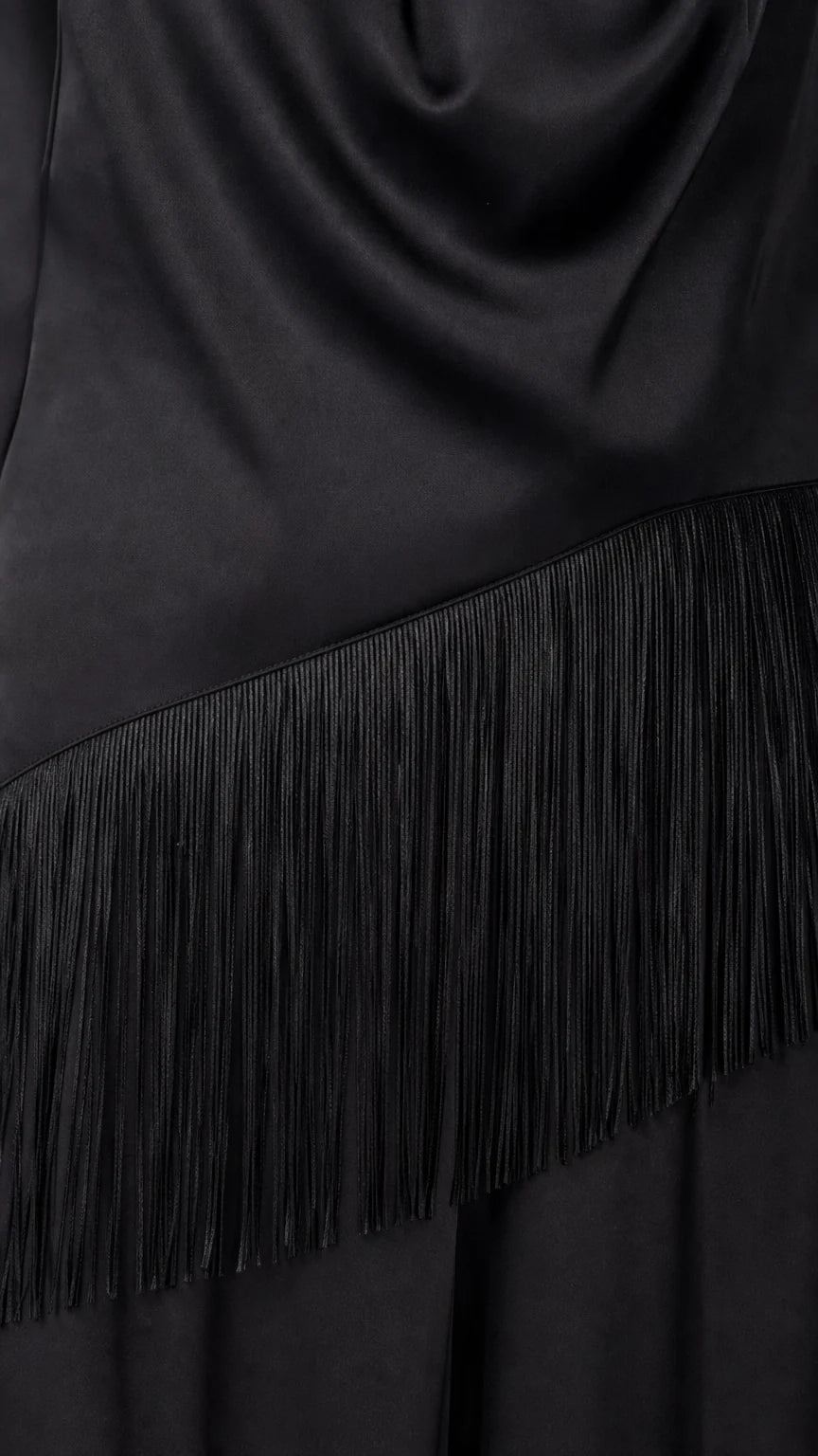 Close-up detail of fringe trim on black satin jumpsuit