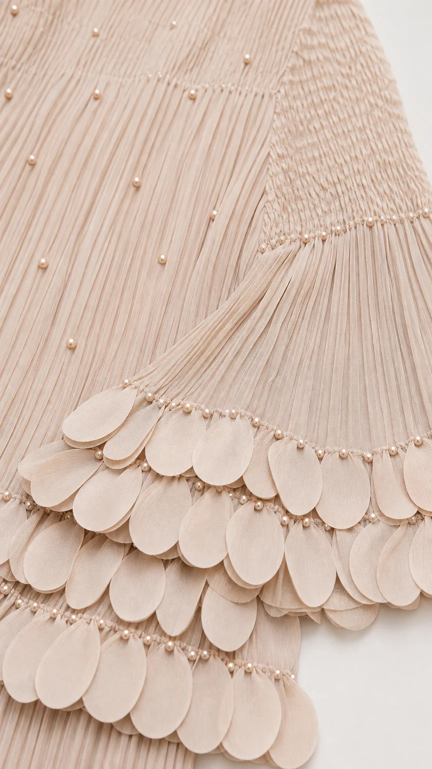 Close-up of pearl embellishments and scalloped sleeve hem