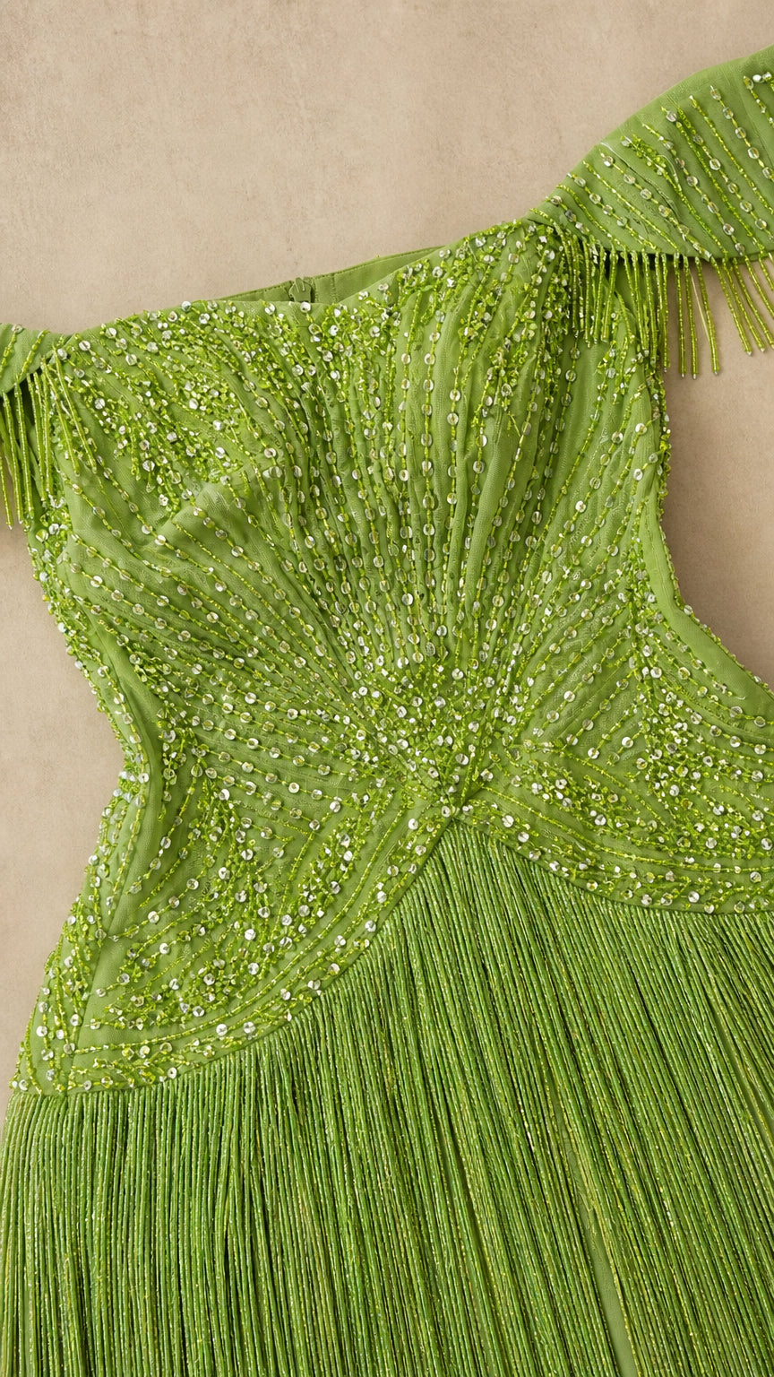 Close-up detail of intricate beadwork and fringe on olive green bodice