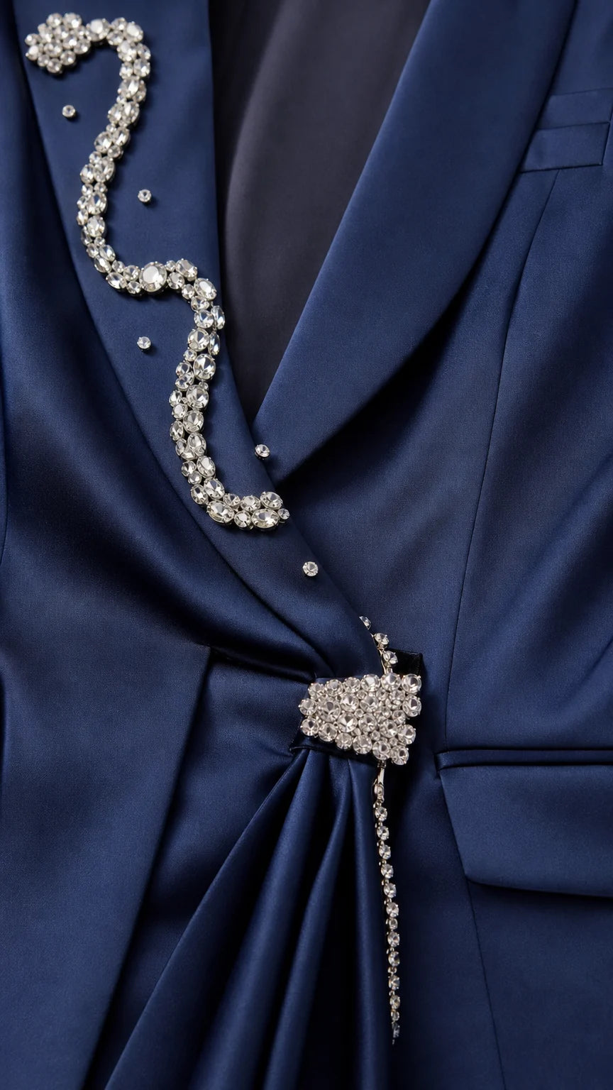Close-up detail of rhinestone lapel and crystal brooch on navy blazer