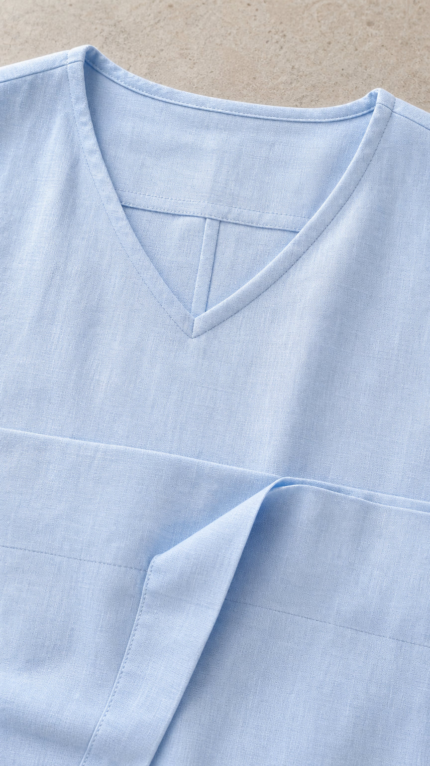Close-up detail of V-neck collar and fabric texture