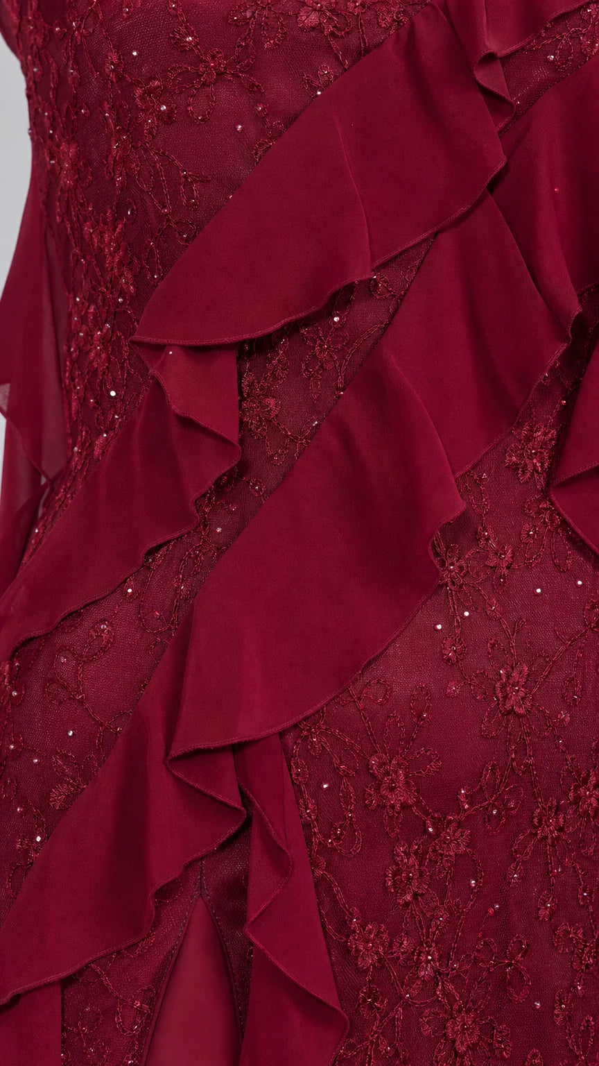 Close-up detail of burgundy lace fabric and cascading ruffles