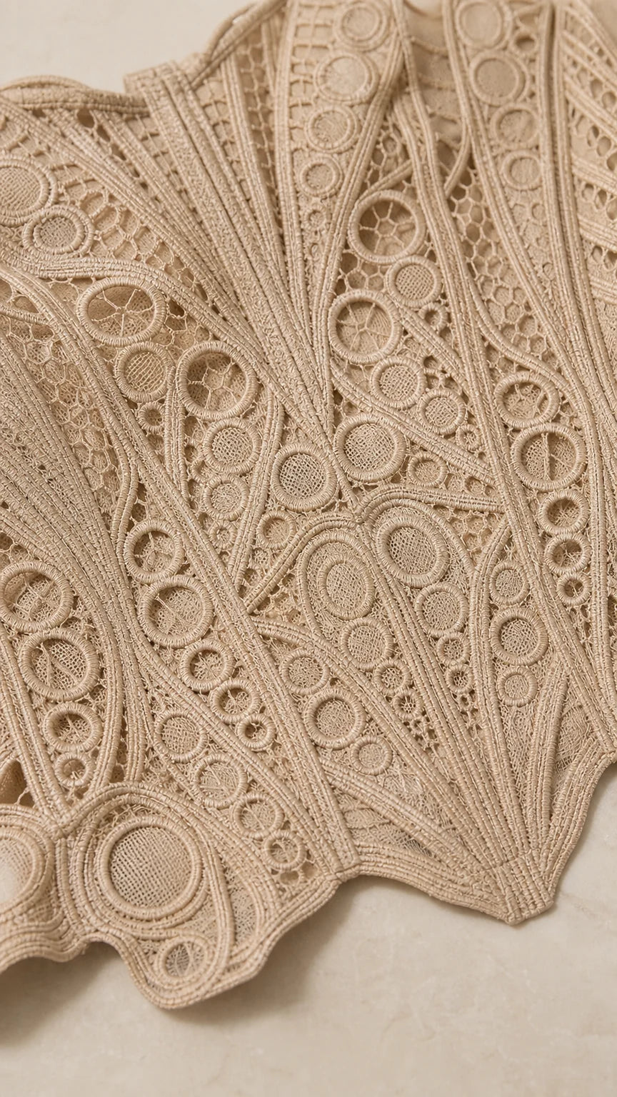 Close up fabric texture view of geometric crochet lace pattern in beige