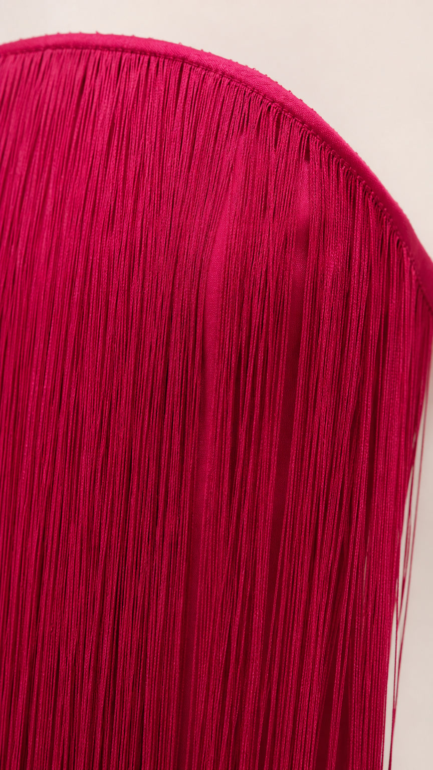Close-up detail of upper neckline and layered fringe tassel texture