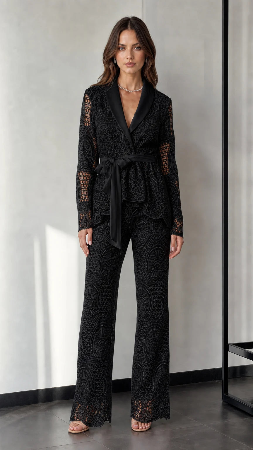 Woman wearing black lace blazer and trousers set