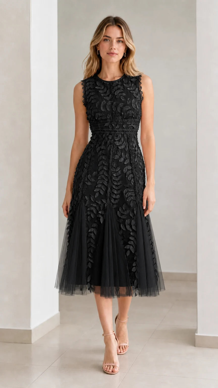 Front view of model wearing black embroidered leaf applique midi dress