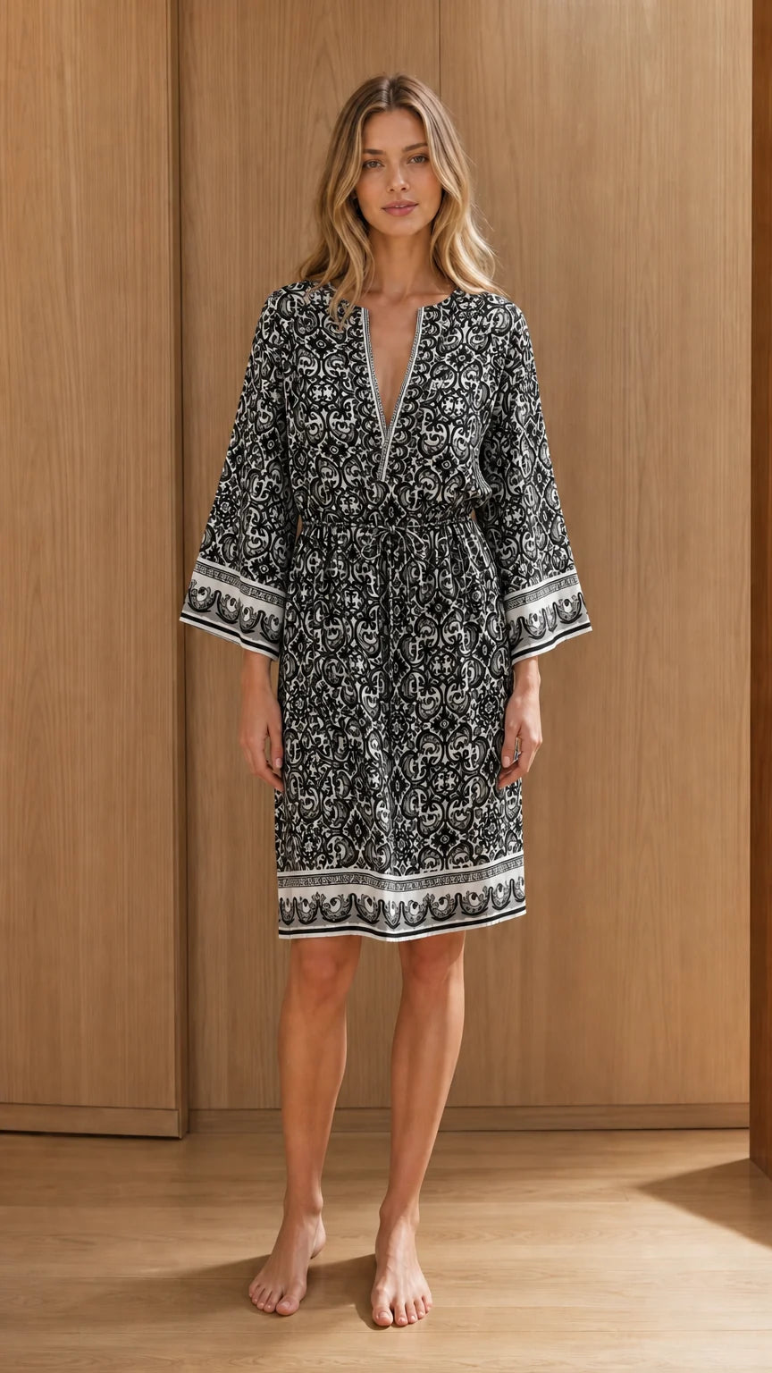 Front view of woman wearing black printed midi dress