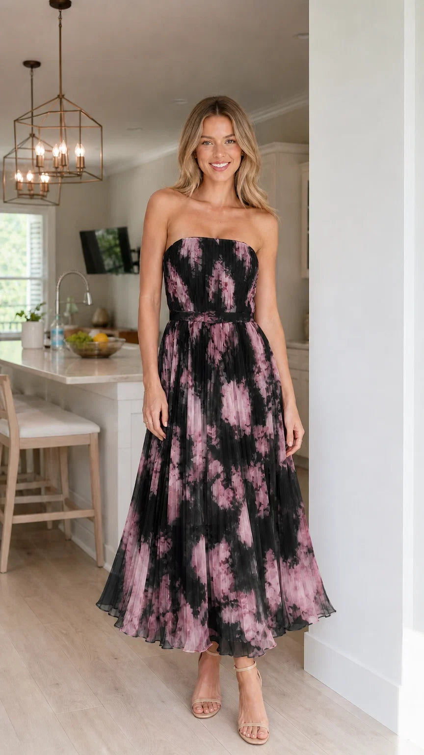 Woman wearing black strapless pleated floral midi dress