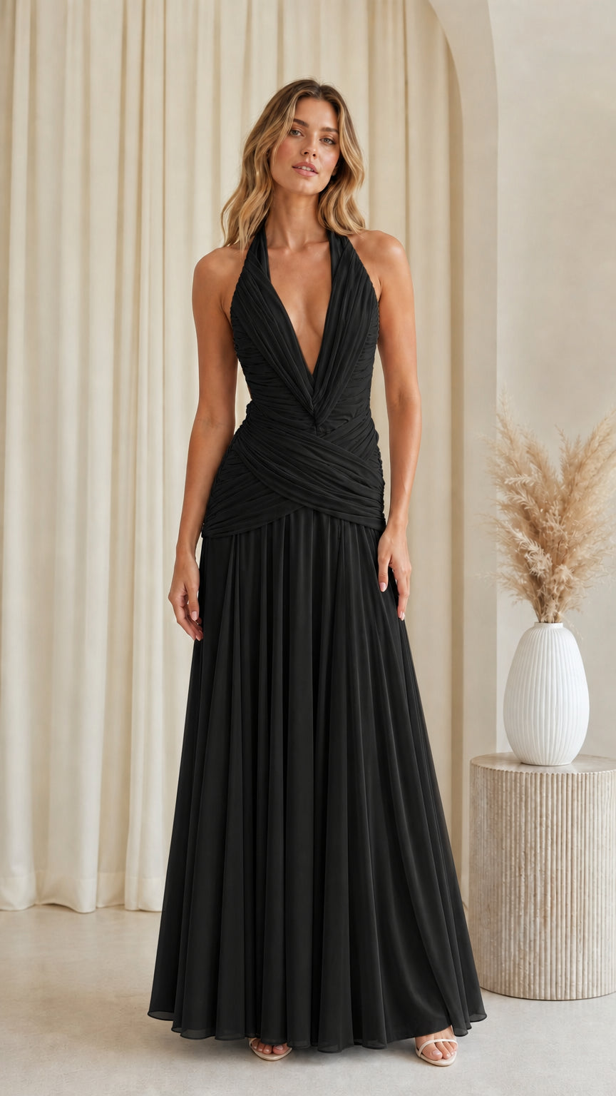 Front view of black halter plunging ruched waist pleated maxi evening dress