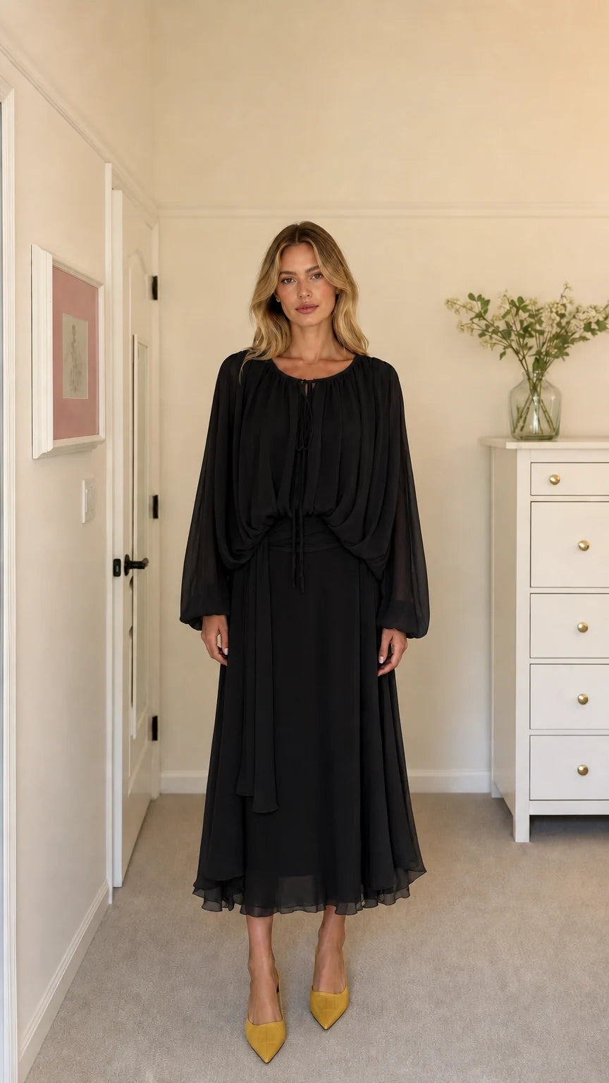 Model wearing black long-sleeve pleated midi dress