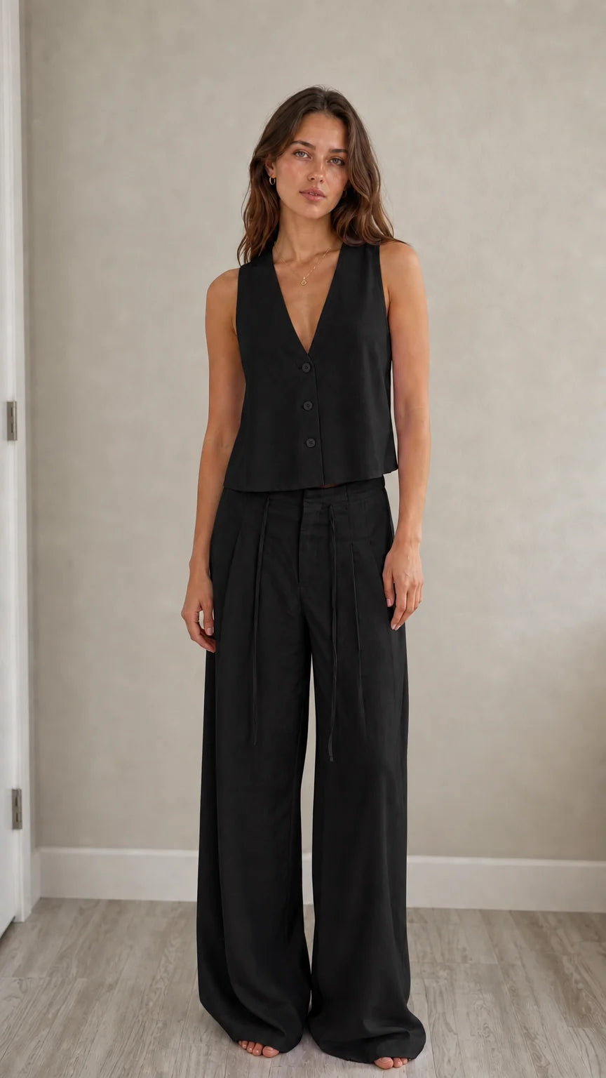 Full-length view of model in black two-piece vest and pants set