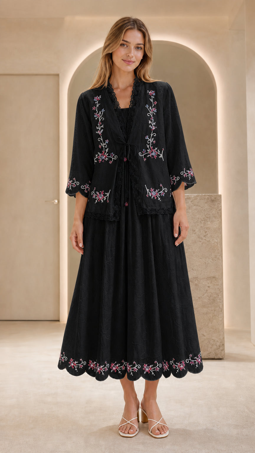 Front view of model wearing black embroidered two-piece dress set