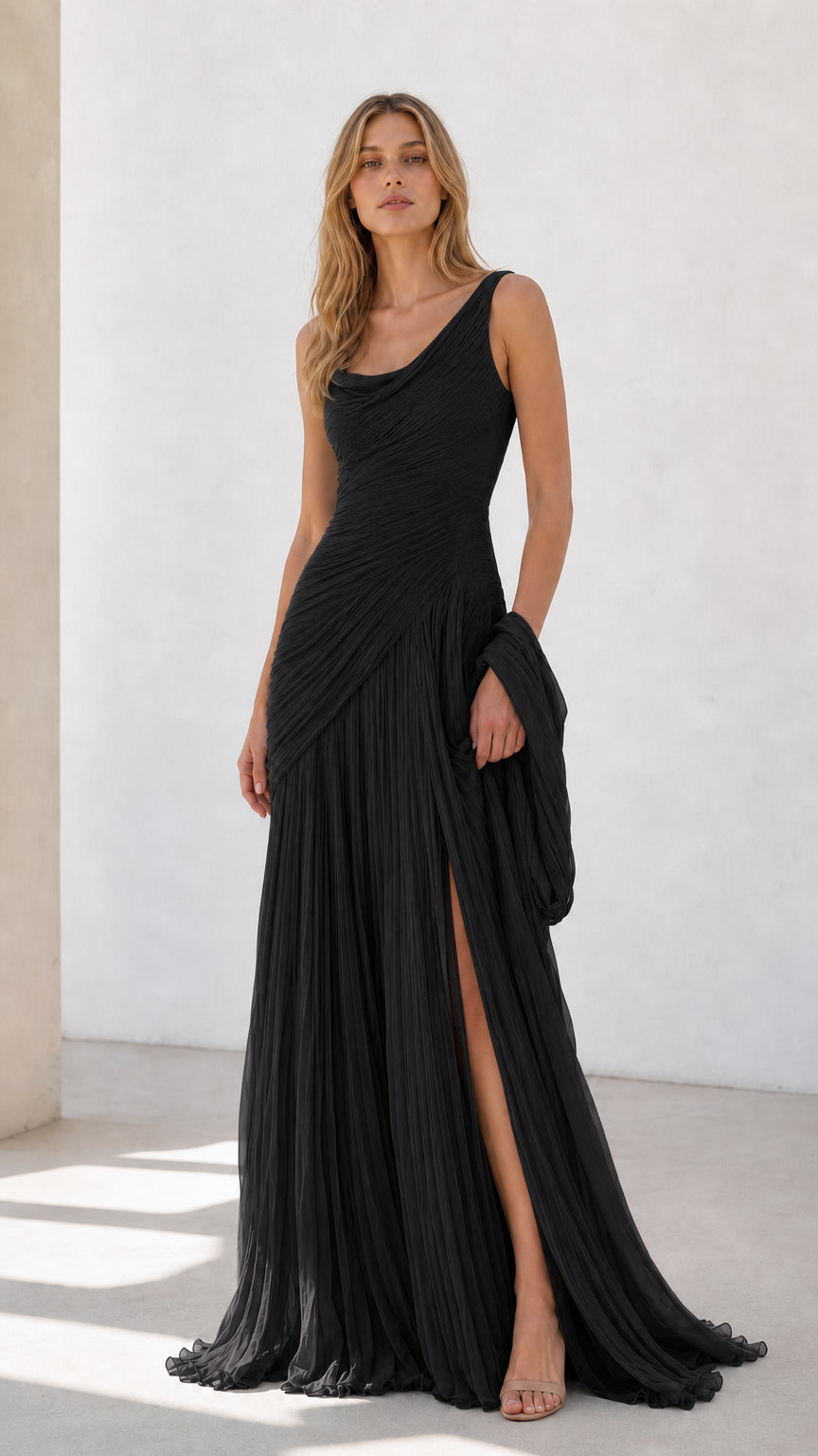 Full view of black pleated draped evening dress with side slit