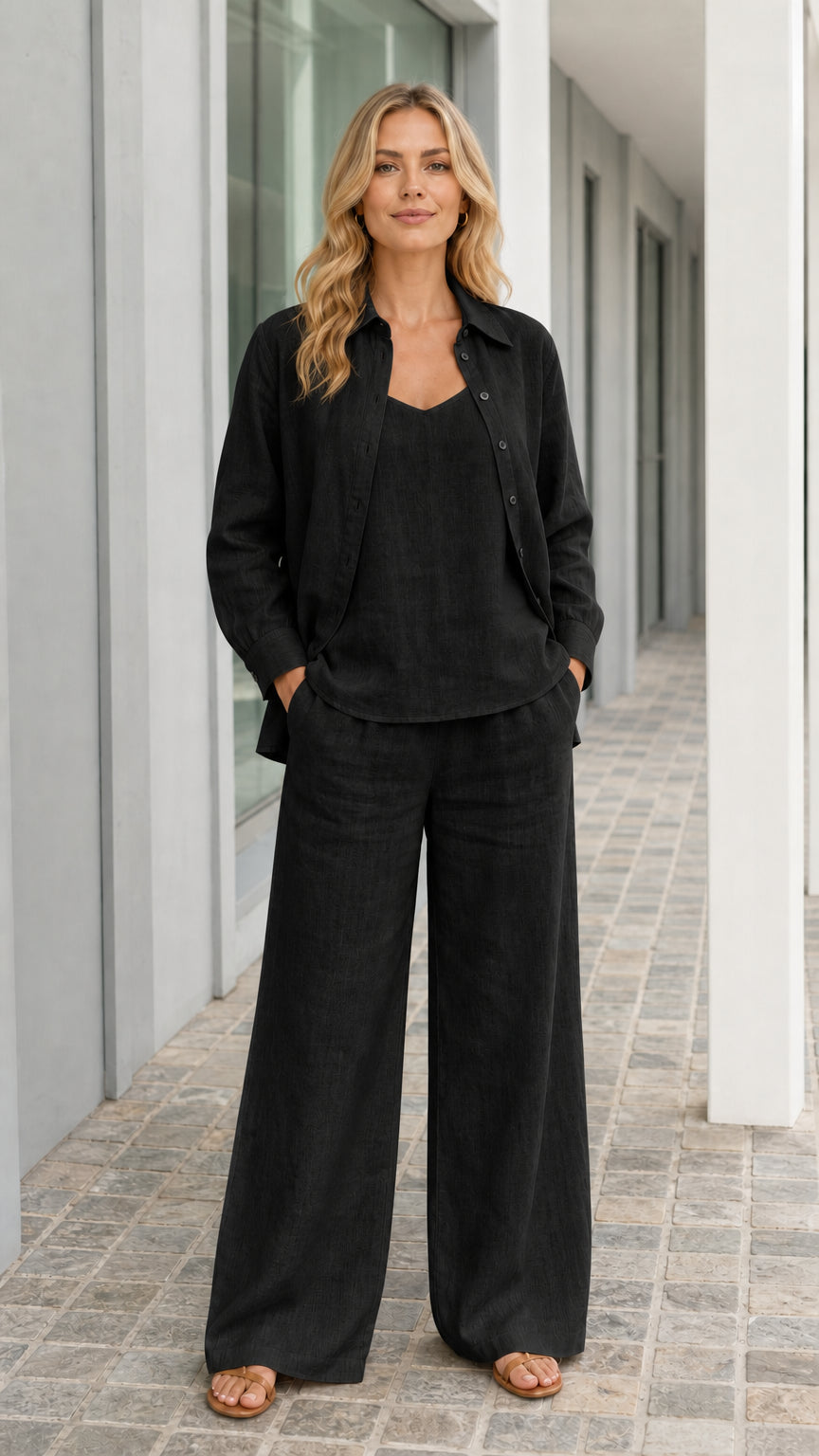 Woman wearing black 3-piece button-down shirt and wide-leg pants set