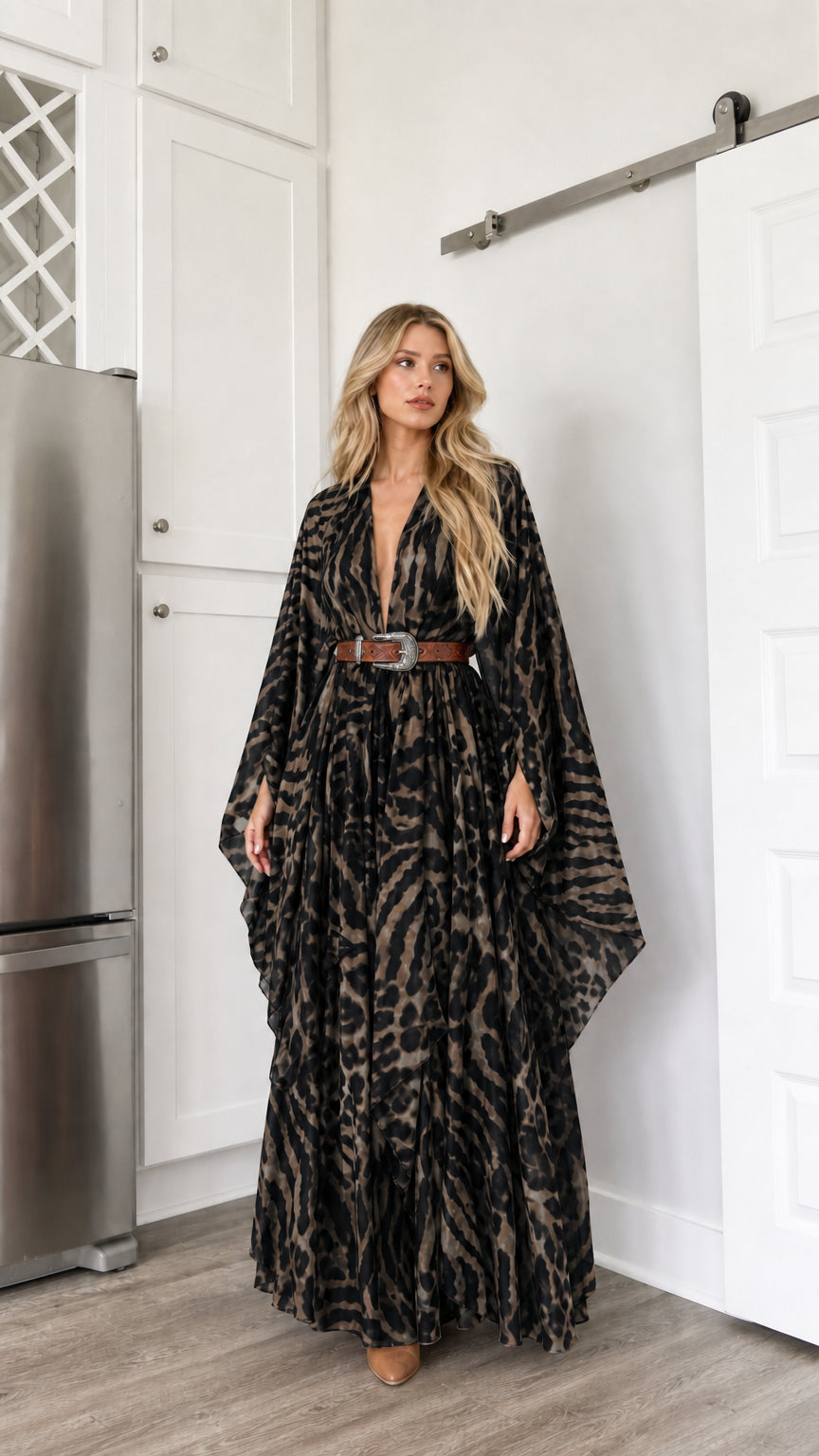 Woman wearing black animal print kimono maxi dress with draped sleeves