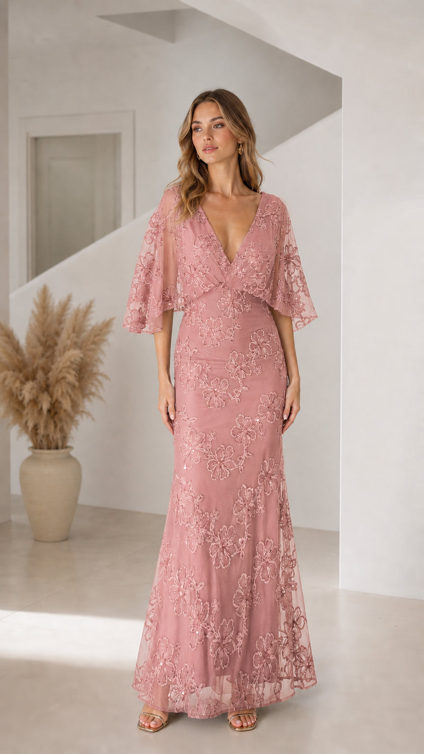 Front view of woman wearing dusty rose floral sequin flutter sleeve formal gown