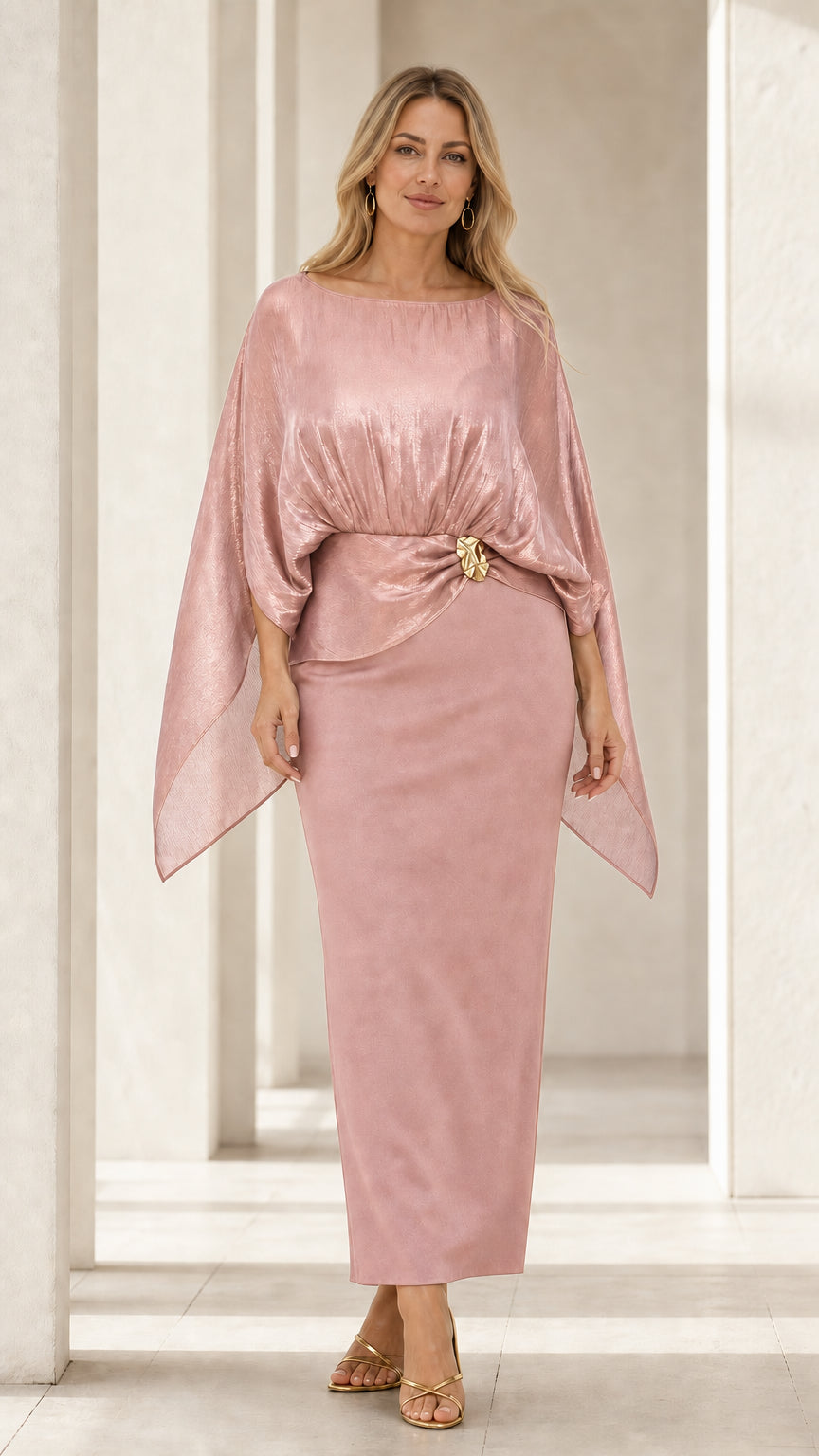 Front view of woman wearing dusty pink shimmering cape bodice column dress