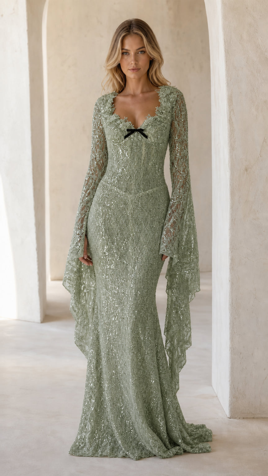 Full front view of sage green sequin mermaid gown with long cape bell sleeves