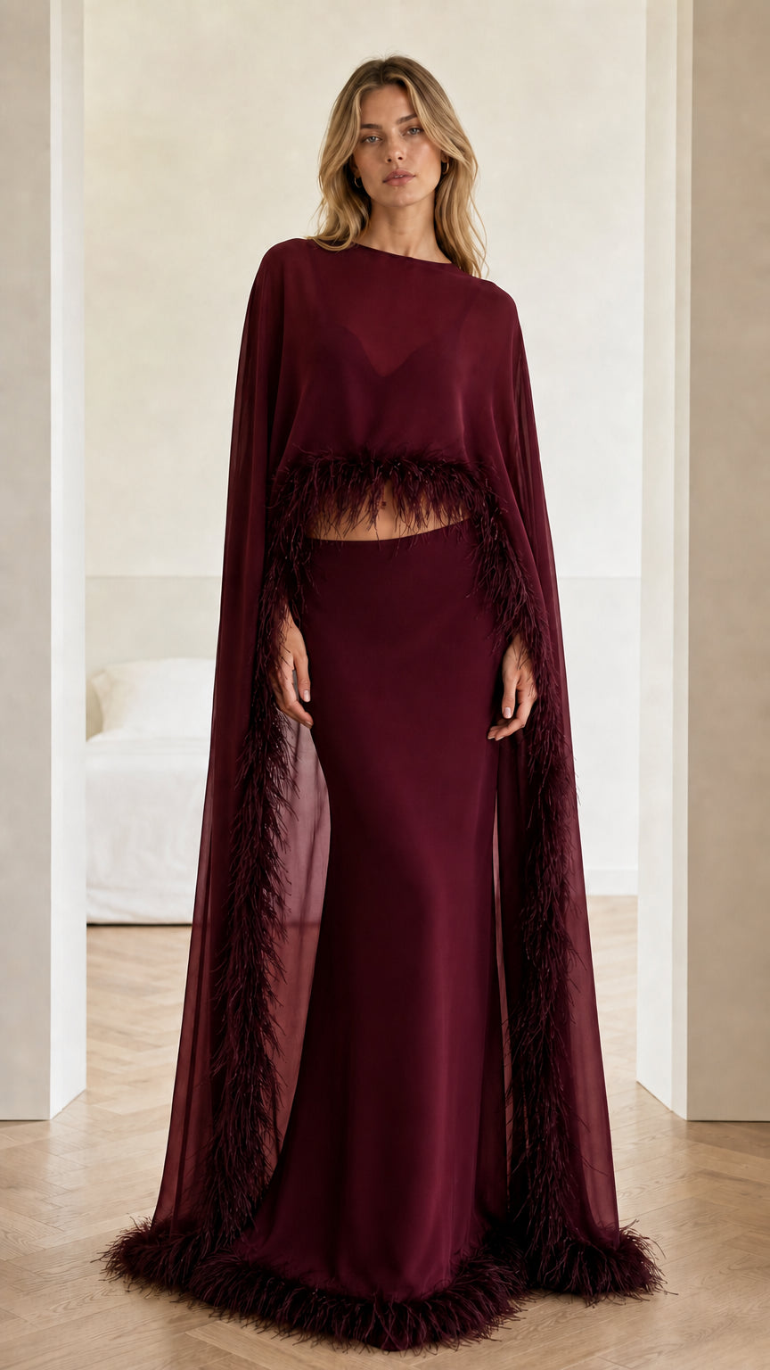 Full-length view of burgundy red feather-trim cape evening gown set