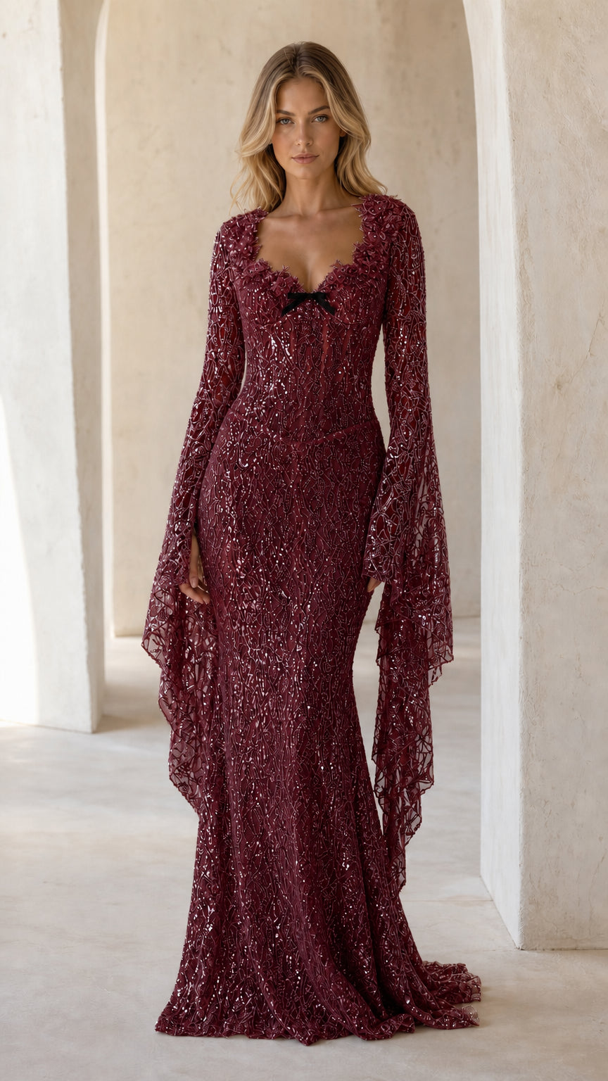 Full front view of burgundy wine sequin mermaid evening gown with dramatic bell sleeves