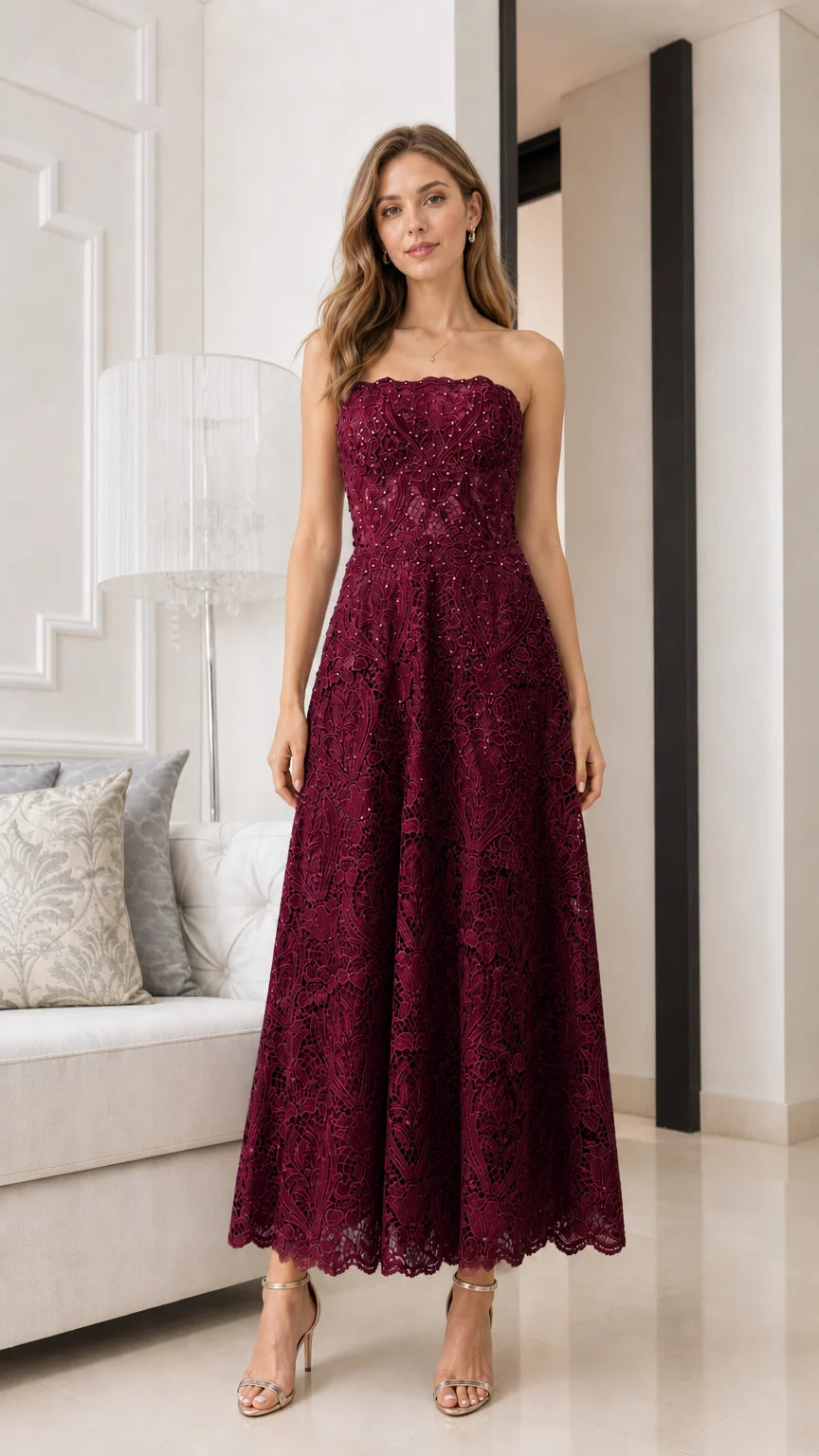 Front view of model wearing burgundy strapless lace midi dress