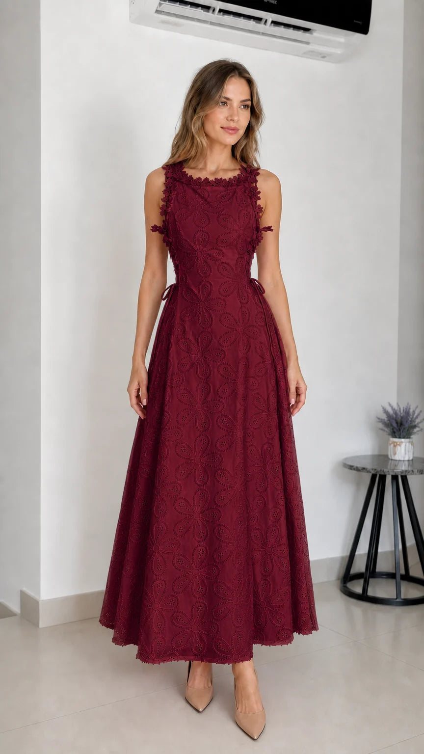 Model wearing burgundy embroidered eyelet maxi dress