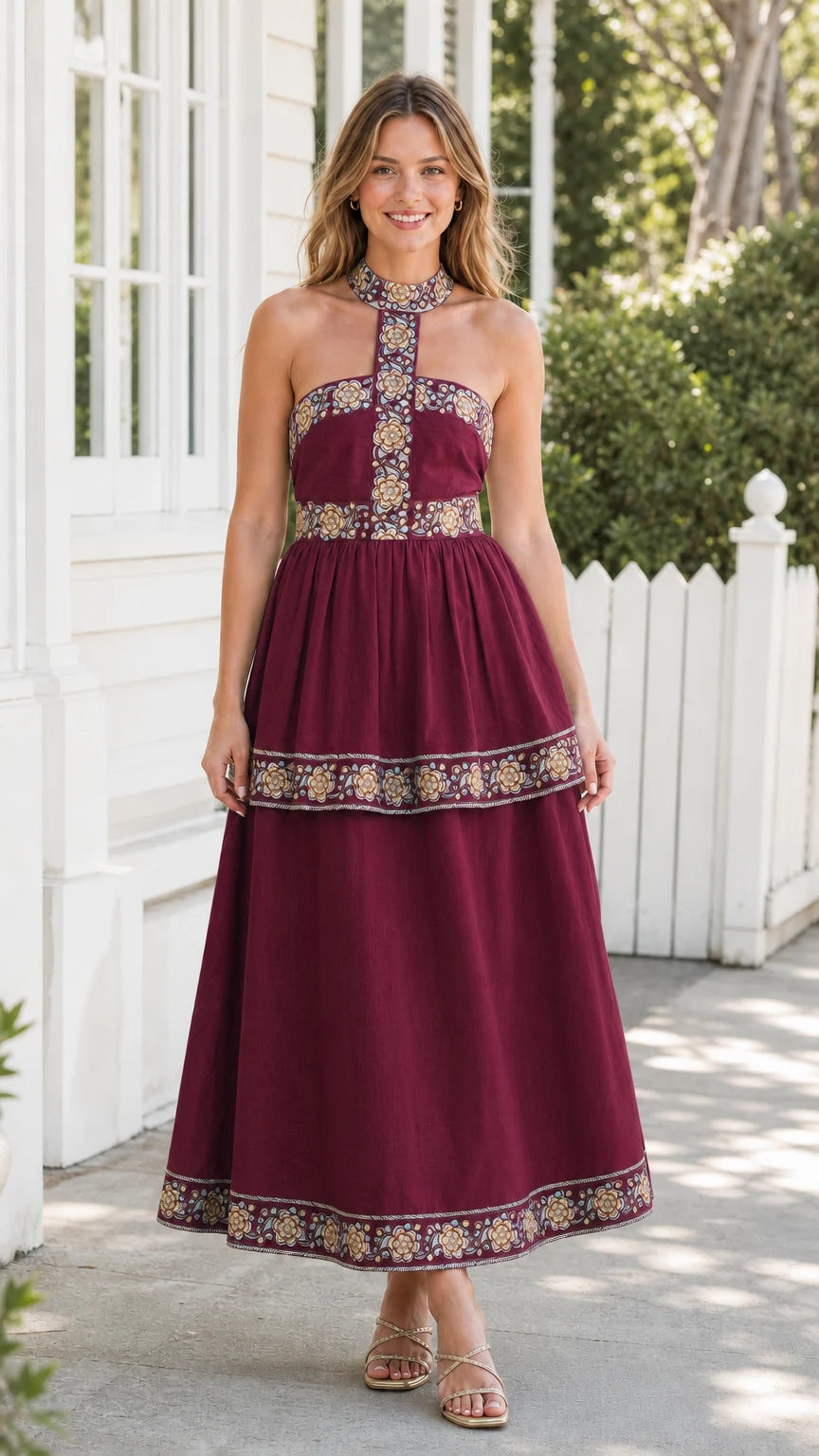 Model wearing burgundy embroidered halter midi dress