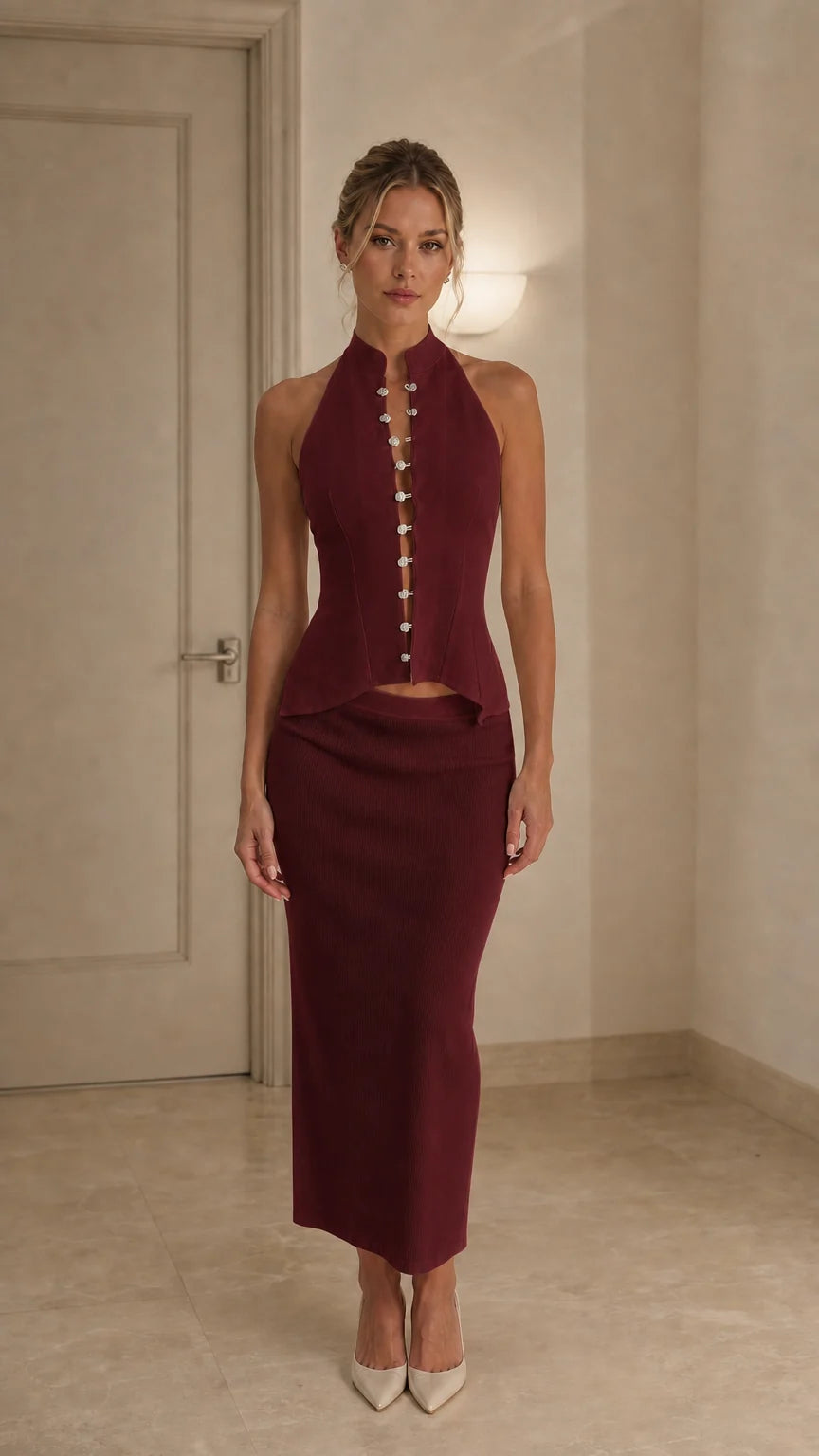 Model wearing burgundy crystal embellished halter top and midi skirt set