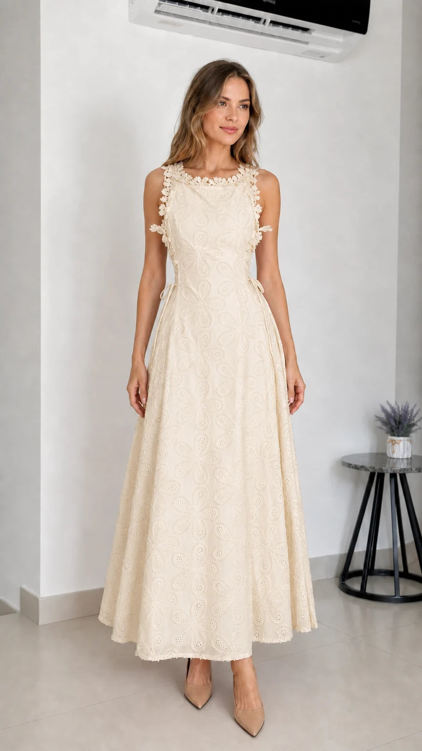 Model wearing beige embroidered eyelet maxi dress