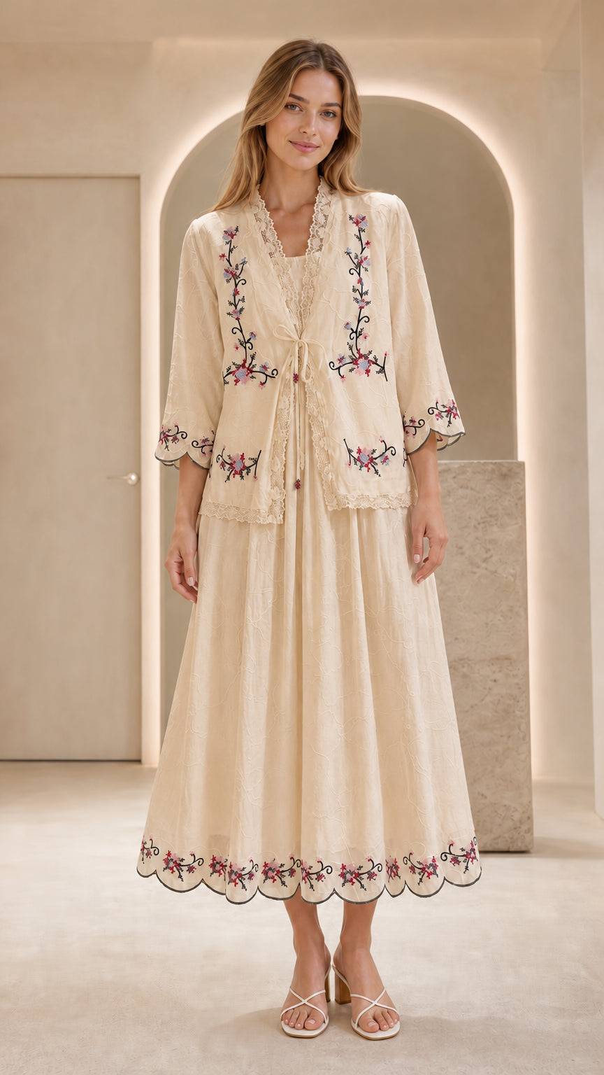 Front view of model wearing beige embroidered two-piece dress set